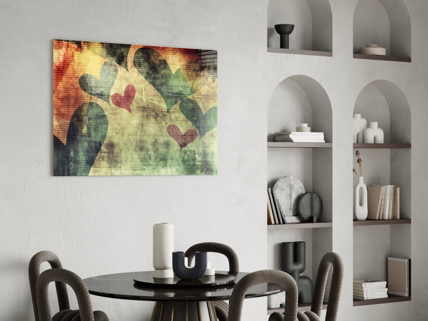 Hearts Hearts glass wall art with red and green heart shapes on textured yellow-green background, displayed above black dining table in modern interior.