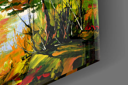 Angled view of colorful glass wall art displaying vibrant autumn hues of orange, yellow, green, and red with dynamic brushstroke patterns.