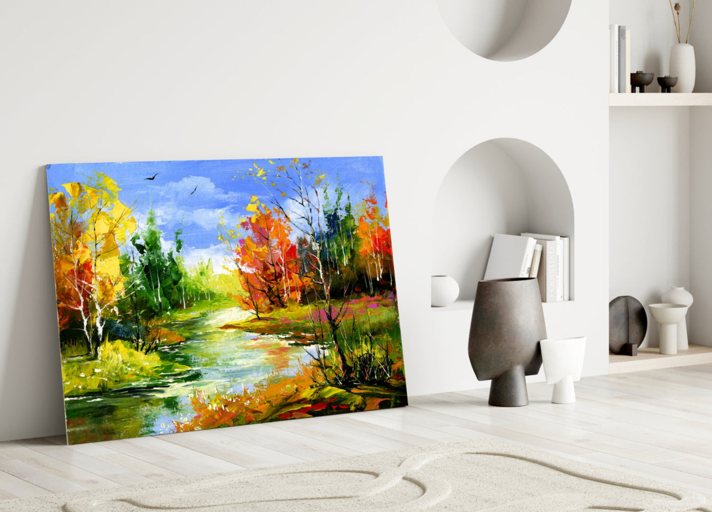 Vibrant autumn landscape glass art leaning against white wall beside decorative objects and shelving.