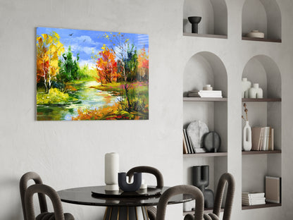 Colorful autumn landscape glass wall art depicting a river with fall foliage displayed above a modern dining table.