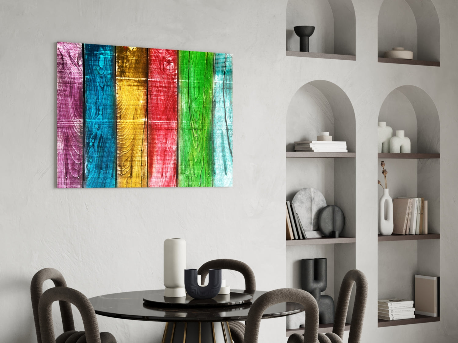 Colorful striped wood-grain glass wall art in pink, blue, yellow, red, and green displayed above a modern dining table with upholstered chairs.