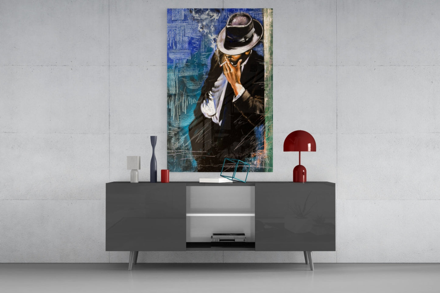 Smoking Glass Wall Art depicting a man in black suit and fedora hat against blue textured background, displayed above gray media console in modern interior.