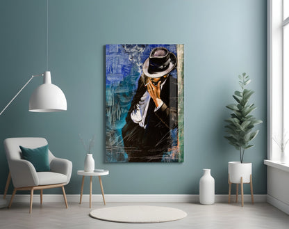 A framed glass wall art depicting a man in a black suit and fedora hat against blue textured background, displayed in a modern living room setting.