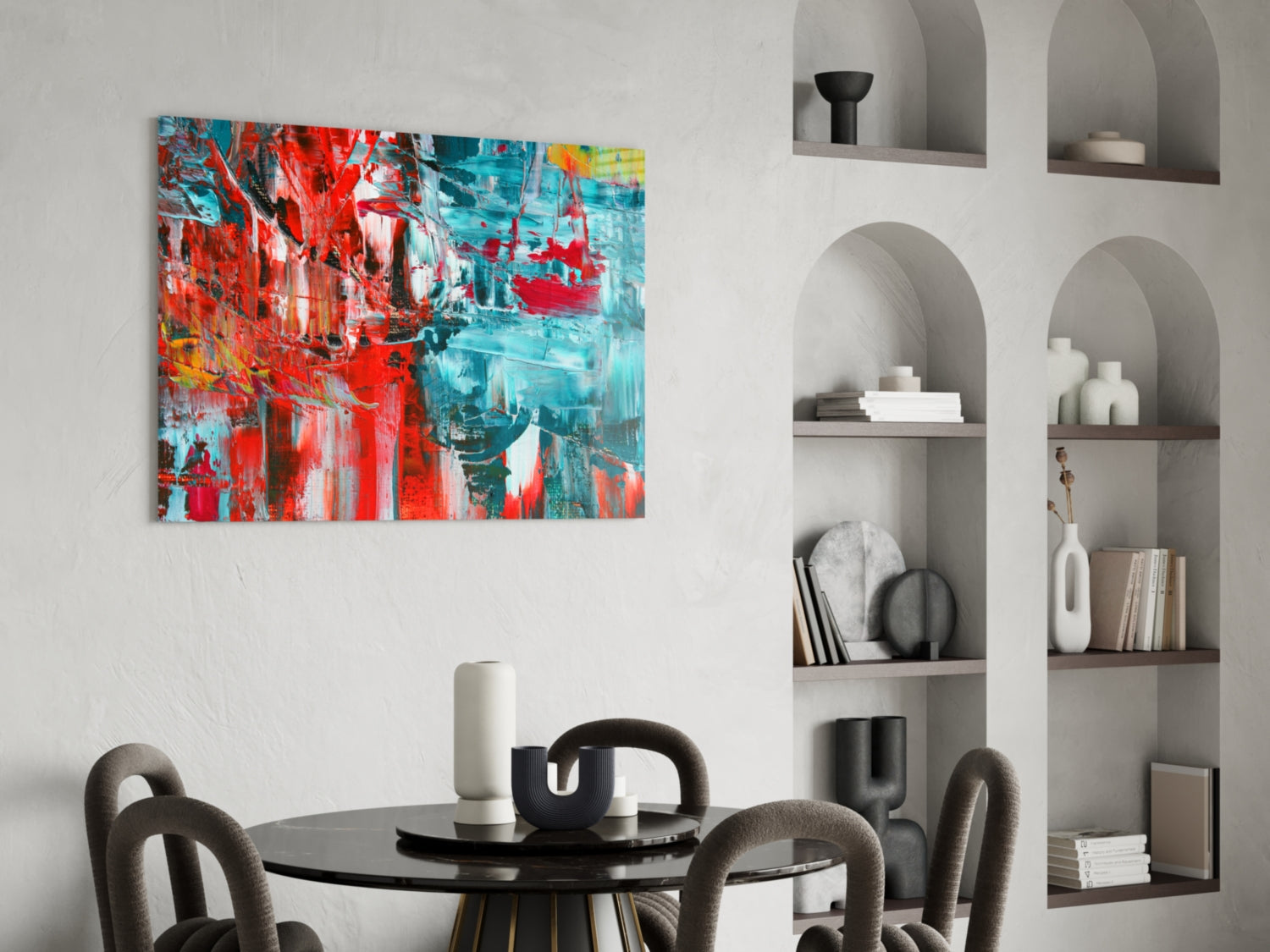 Abstract Reflection Glass Wall Art displaying red and turquoise brushstrokes hung above a black dining table with grey chairs.