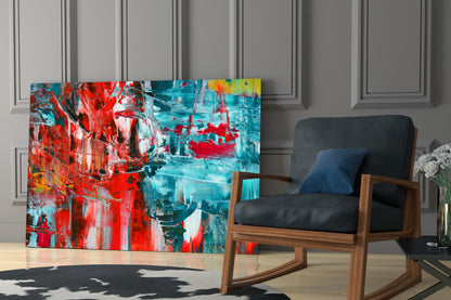 Abstract Reflection Glass Wall Art displaying red and turquoise brushstrokes displayed in modern living room with wooden chair.
