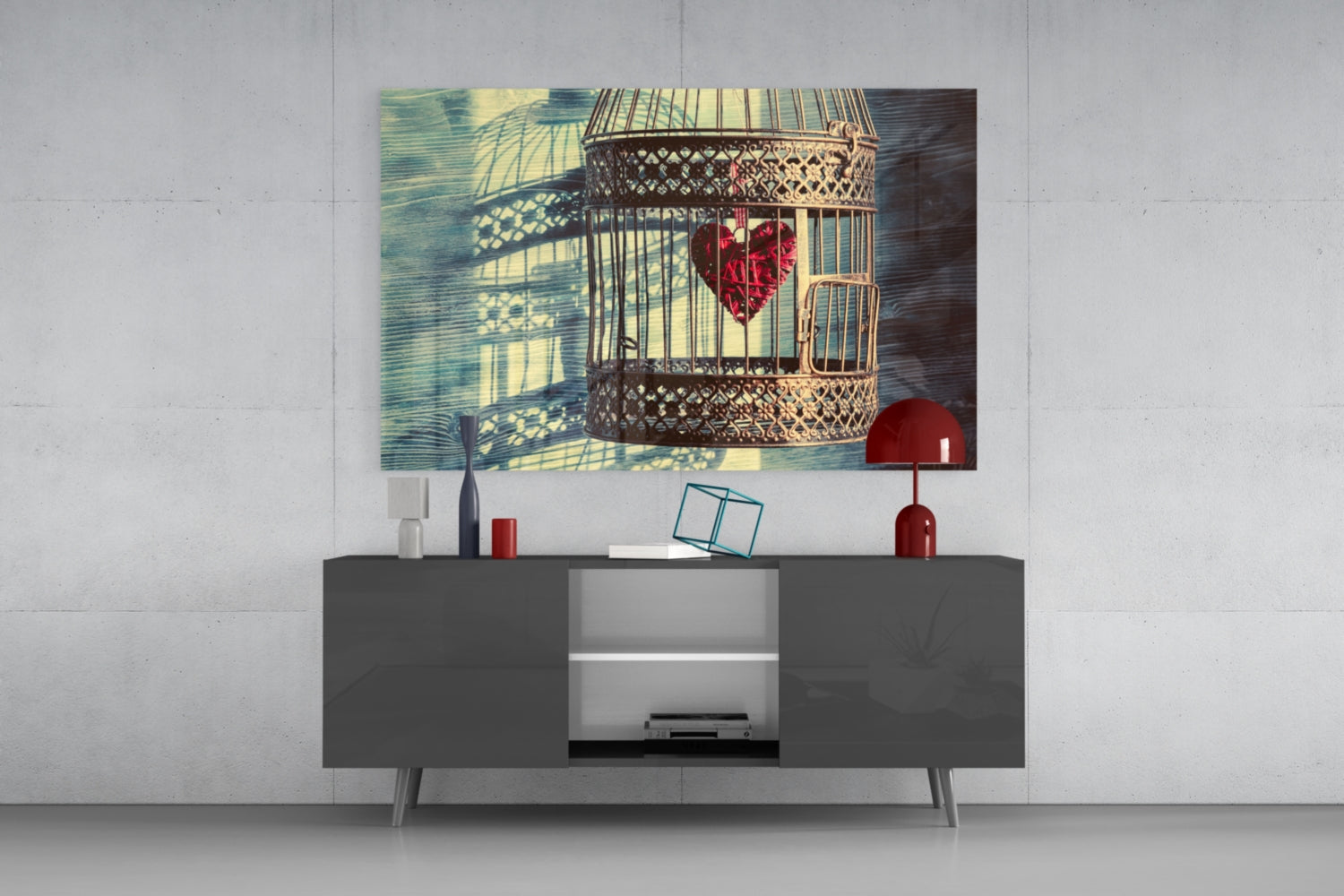 Caged Heart Glass Wall Art displayed above a dark gray media console, showing a decorative birdcage with red flowers and window shadows.
