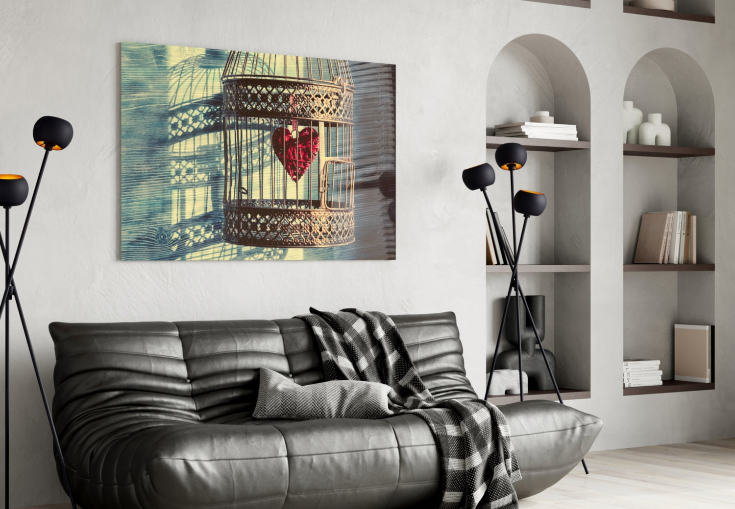 Caged Heart Glass Wall Art displayed above a black leather sofa in a modern living room with arched shelving.