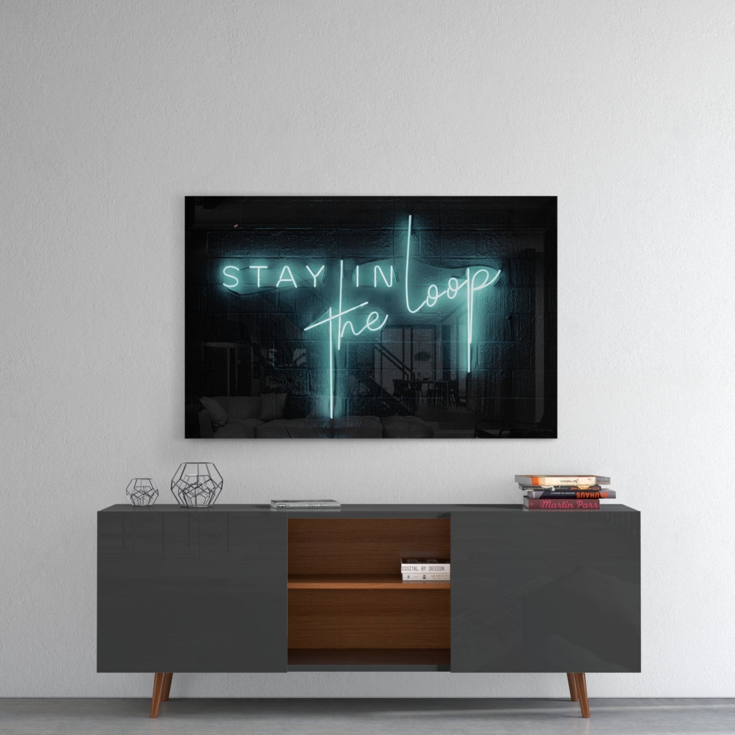 Neon glass wall art displaying "Stay in the Loop" in cyan lettering, mounted above a mid-century modern console table in a living room setting.