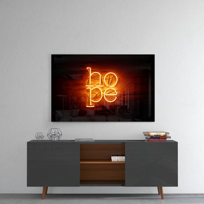 Orange neon "hope" sign displayed on black framed glass above gray mid-century media console with wooden shelving.