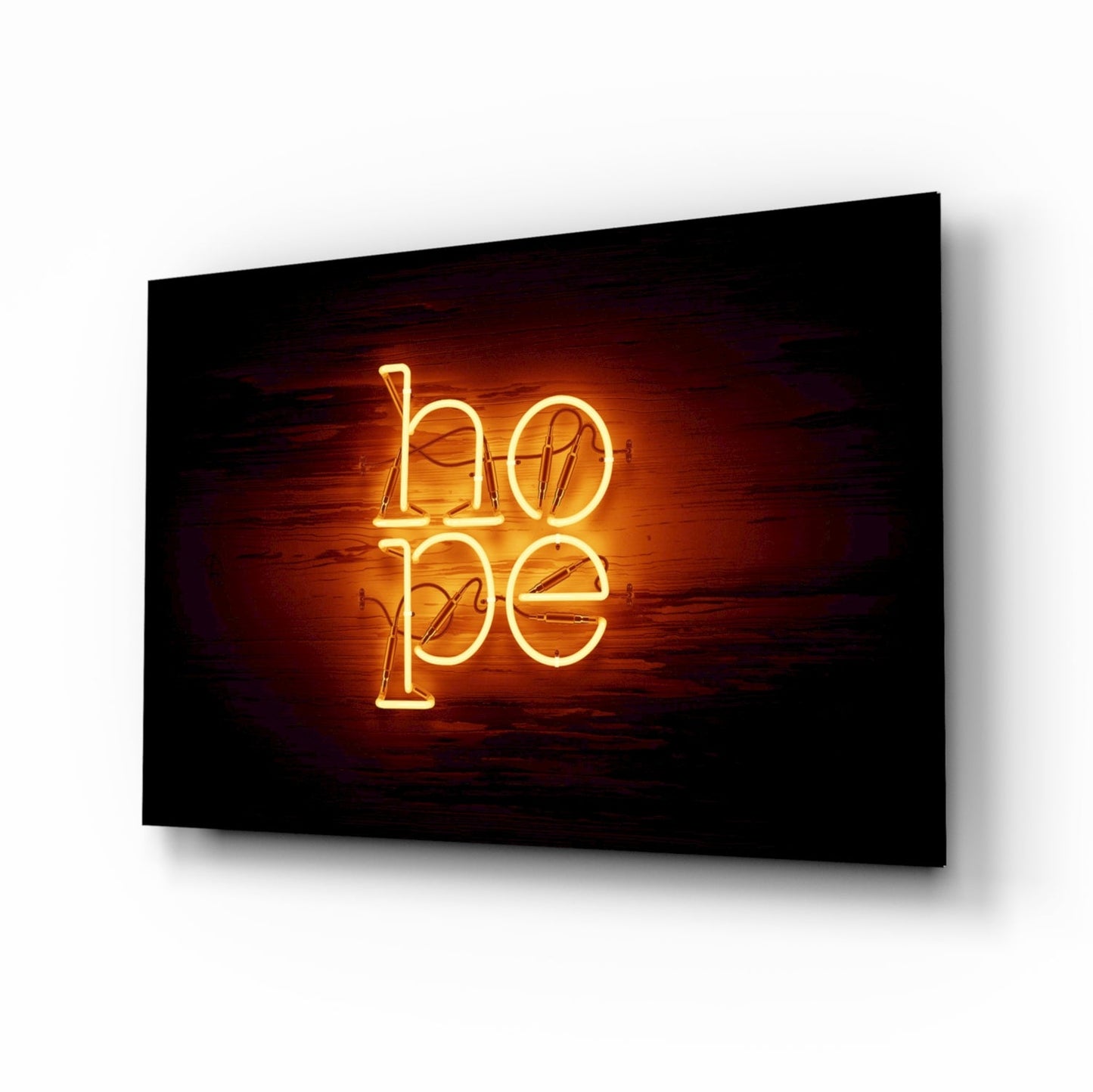 Neon glass wall art displaying "hope" in glowing gold letters against a dark wooden background, mounted on a wall at an angle.
