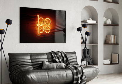 Neon "hope" wall art in gold lettering displayed above a black leather sofa in a modern living room interior.