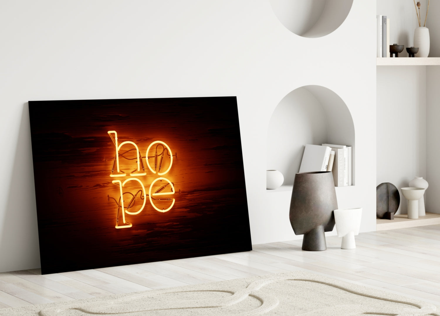 Neon "hope" glass wall art with glowing golden lettering leaning against white wall in minimalist interior setting.