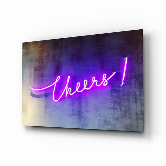Purple neon script reading "Cheers!" glows on textured gray wall art displayed at an angle.