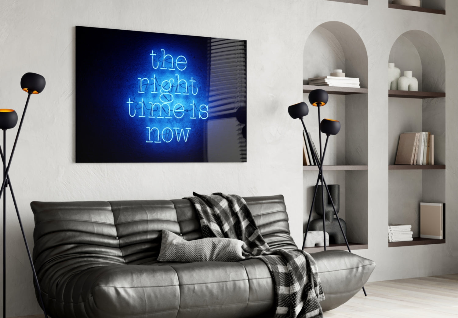 Blue neon glass wall art displaying "the right time is now" text mounted above gray leather sofa in modern living room interior.
