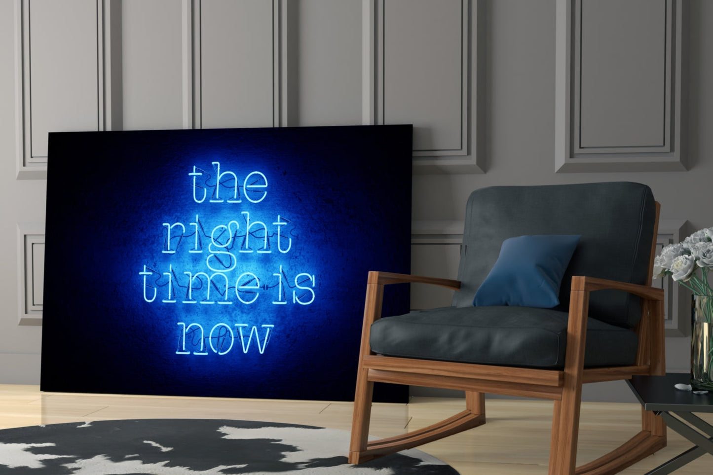 Neon glass wall art displaying "the night time is now" in bright blue lettering mounted on dark display screen in modern living room setting with wooden chair.
