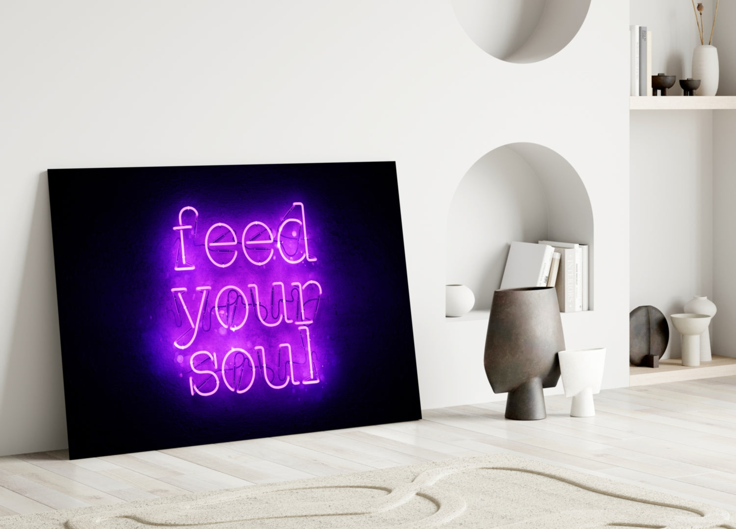 Purple neon "feed your soul" text glows on black glass panel leaning against white wall in minimalist room setting.
