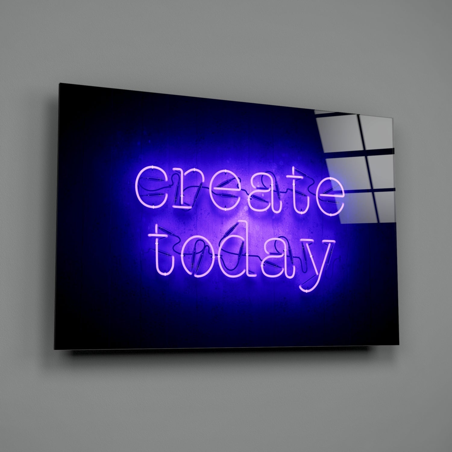 Blue neon sign reading "create today" mounted on dark glass panel against gray wall, angled three-quarter view.