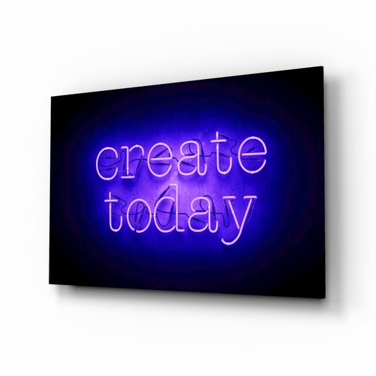 Blue neon "create today" text glowing on black glass panel displayed at an angle against white background.