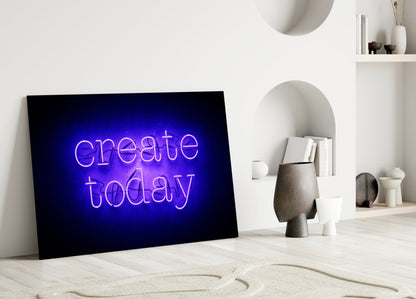 Purple neon "create today" glass wall art leaning against white wall in minimalist interior setting.
