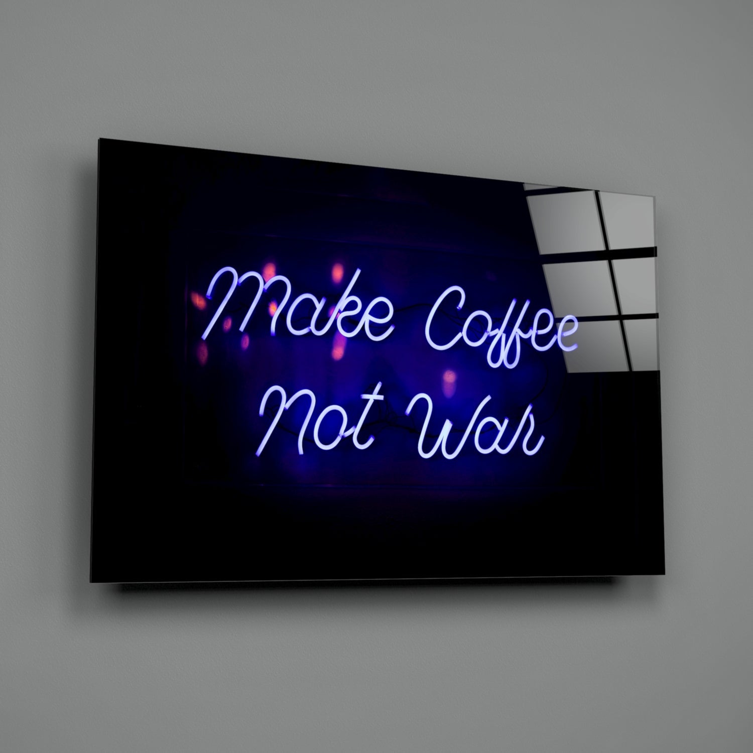 Angled perspective of neon-style glass wall art displaying blue and white glowing text reading "Make Coffee Not War" against dark background.