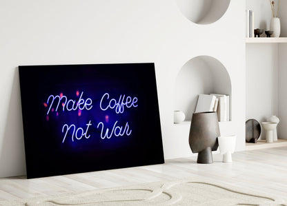 Black glass panel with blue and pink neon-style "Make Coffee Not War" text displayed in minimalist white room setting with shelving and decorative objects.
