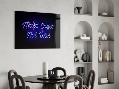 Neon "Make Coffee Not War" glass wall art in blue and pink displayed above a black round dining table with gray chairs and white shelving.