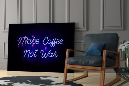 Neon glass wall art displaying "Make Coffee Not War" in blue and pink lettering, displayed in a modern living room with a wooden chair and paneled walls.