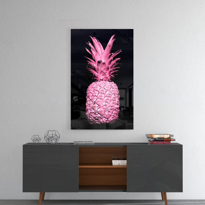 Vibrant pink pineapple glass art displayed on white wall above mid-century modern sideboard with geometric decor.