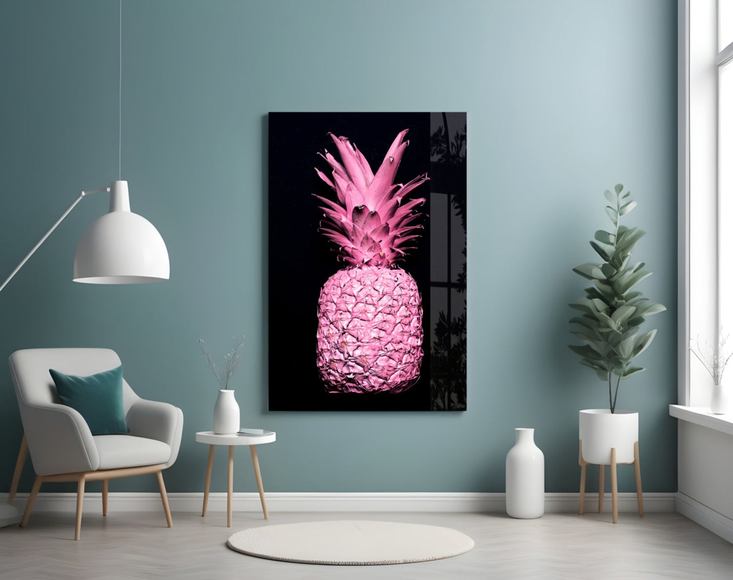 Pink pineapple glass wall art displayed in a modern living room with mint green walls, white furniture, and potted plants.