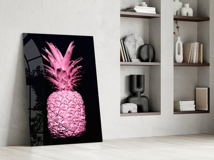 Pink neon pineapple glass art leaning against white wall beside built-in shelving with decorative objects.