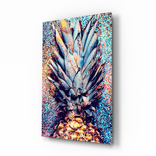 Angled view of glass wall art featuring a pineapple with blue-gray leaves and golden fruit against a colorful speckled turquoise and coral background.