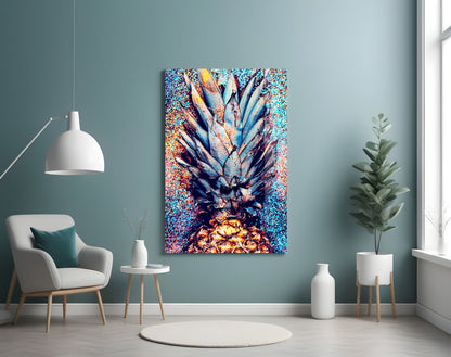 Colorful glass pineapple art displayed on teal wall above white chair in modern living room setting.