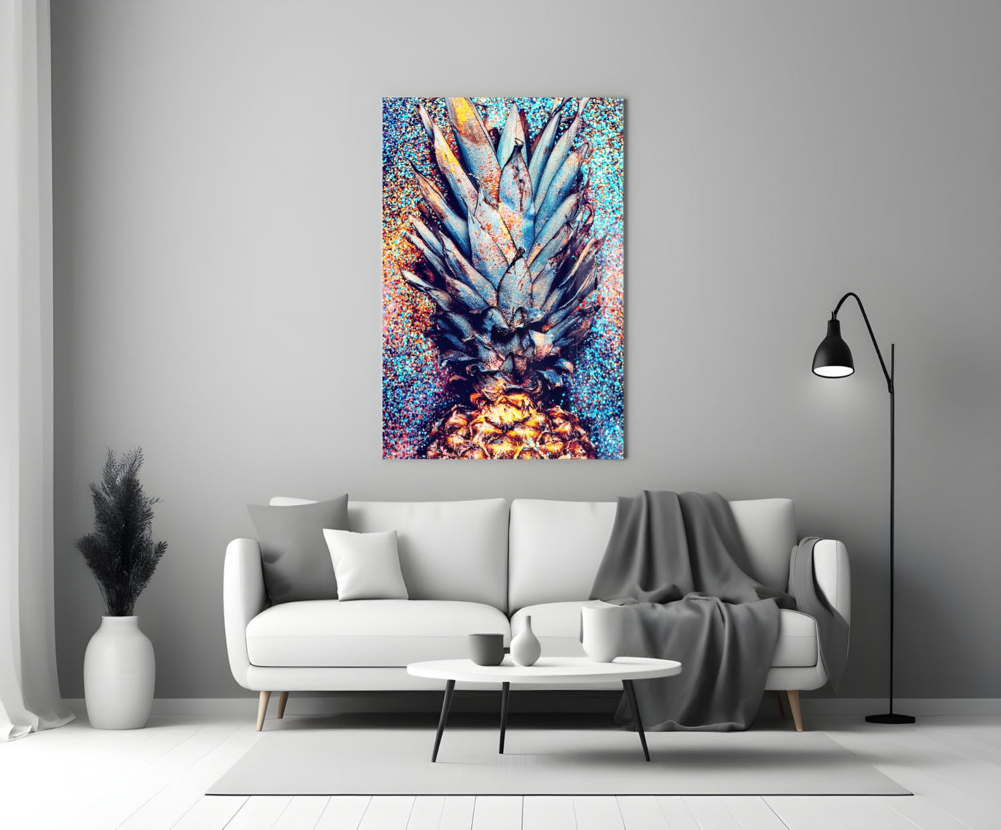 Colorful pineapple glass art hung above white sofa in modern living room setting with black arc lamp.