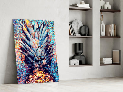 Colorful pineapple glass art leaning against white wall beside shelving unit displaying decorative objects and books.