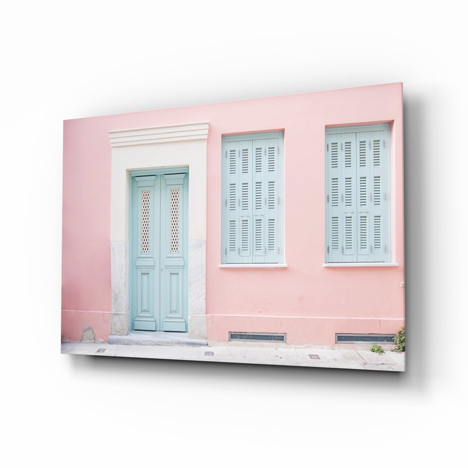 Pink-painted colonial building facade with turquoise door and louvered shutters displayed as glass wall art.