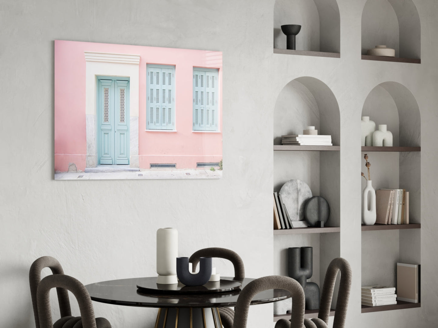 Pink House Glass Wall Art displayed above a black round dining table with gray chairs in a modern interior setting.
