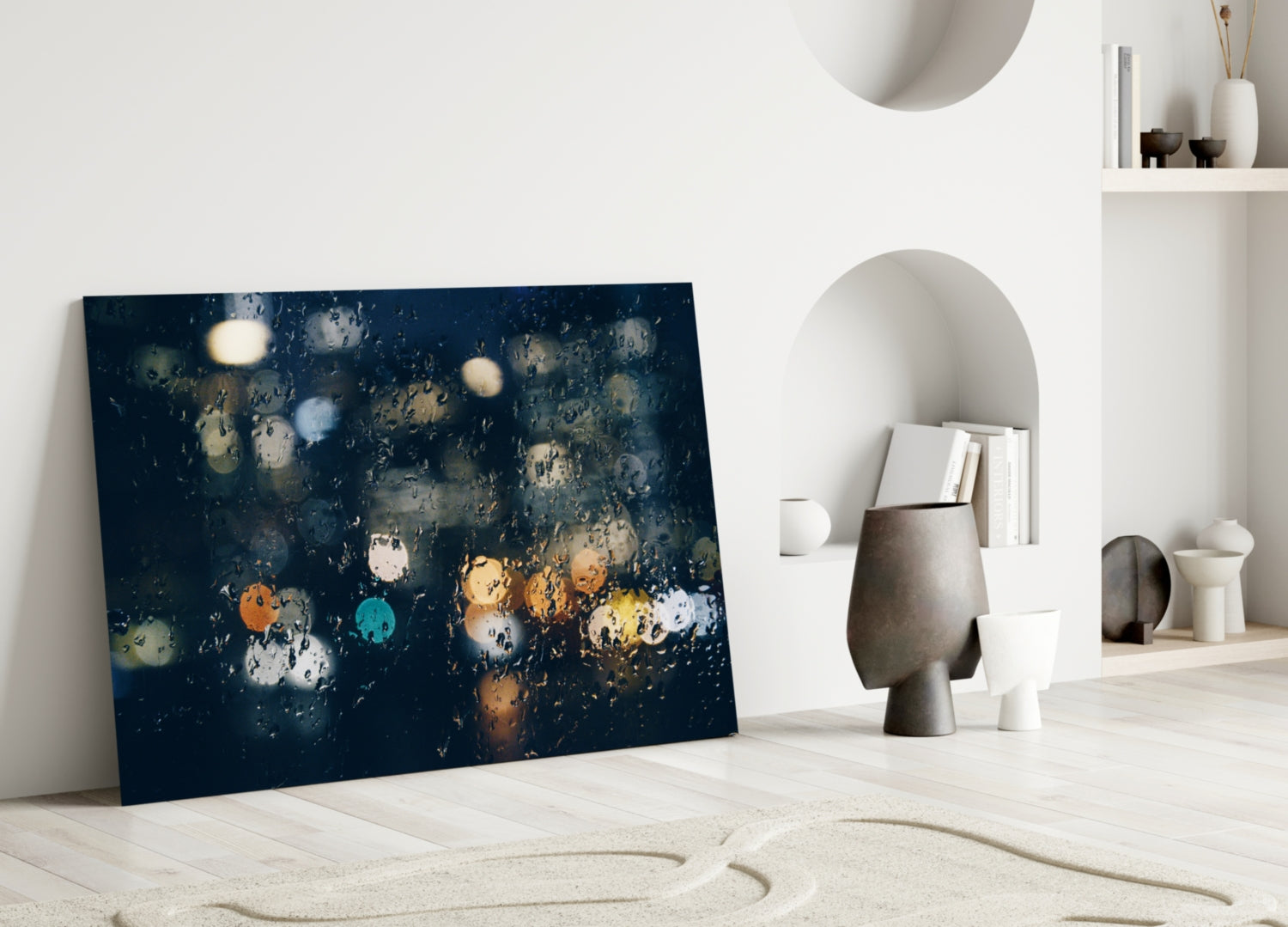 Rain Glass Wall Art displaying dark blue background with colorful bokeh raindrops, leaning against white wall in minimalist interior setting.