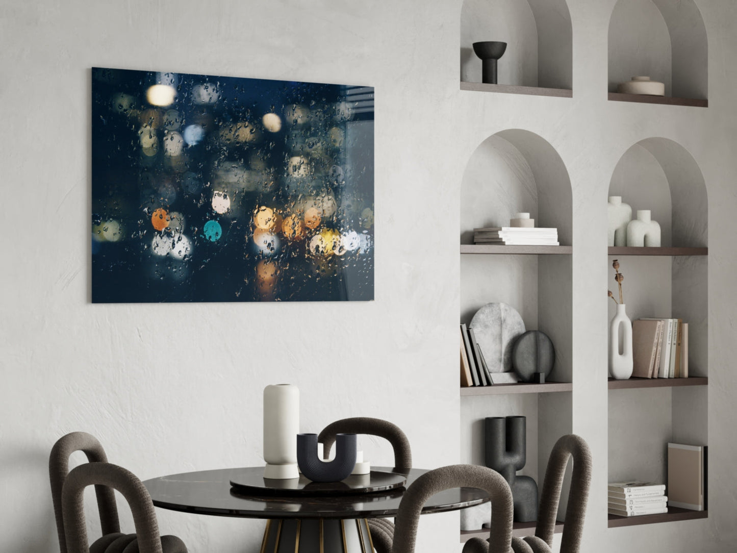 Dark blue canvas with colorful raindrops and bokeh lights displayed above black dining table in modern interior.