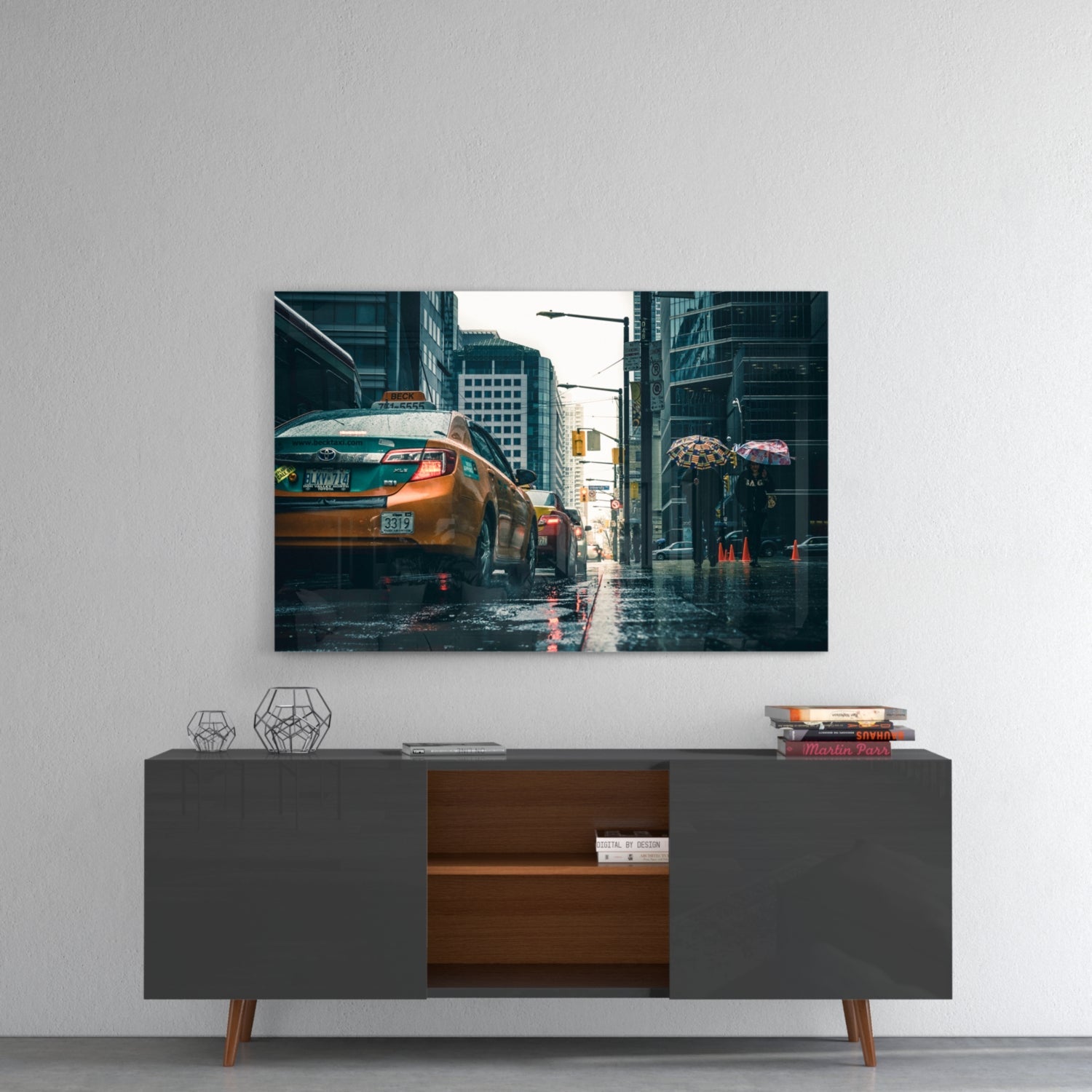 Glass wall art featuring rainy New York City street scene with yellow taxi cabs and pedestrians with umbrellas, displayed above mid-century modern credenza.