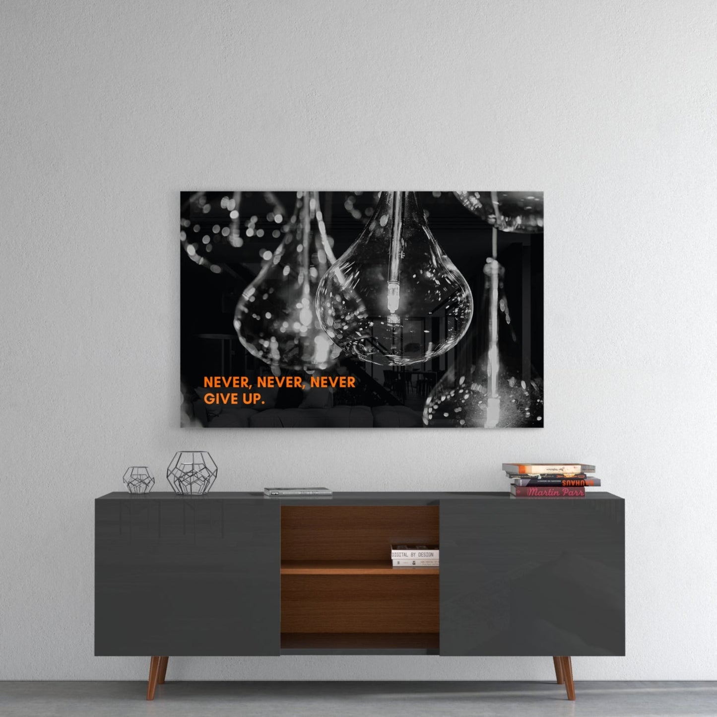 Black and white glass wall art featuring water droplets with orange text "NEVER, NEVER, NEVER GIVE UP" mounted above a mid-century modern console table.