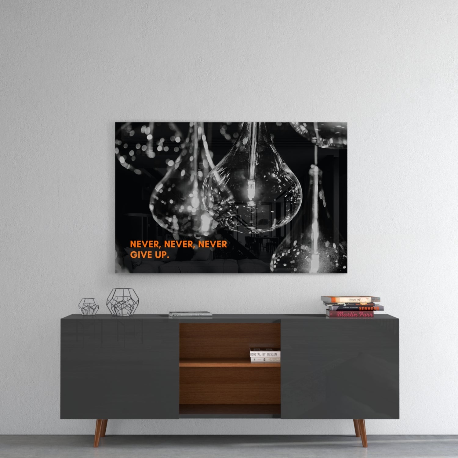 Black and white glass wall art featuring water droplets with orange text "NEVER, NEVER, NEVER GIVE UP" mounted above a mid-century modern console table.