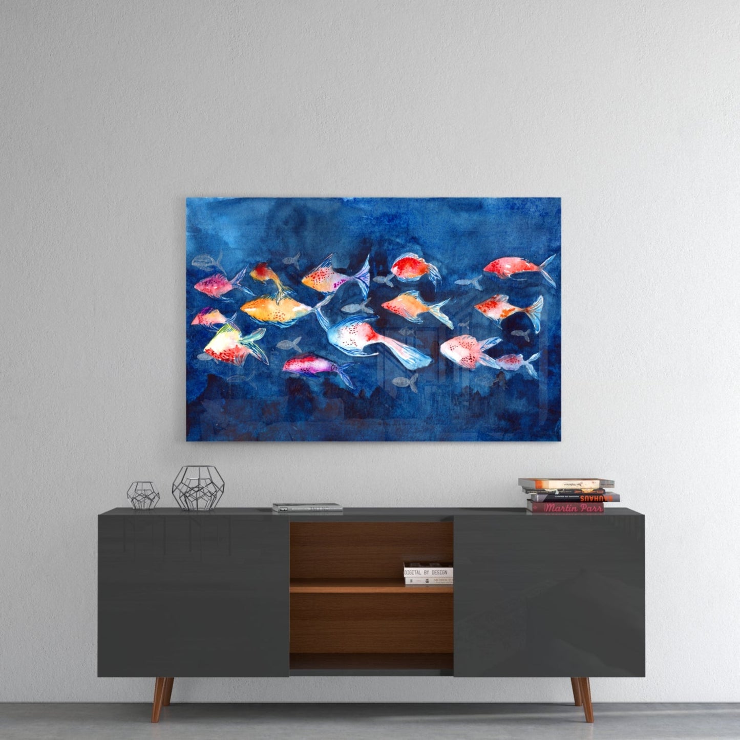 Colorful fish illustration glass wall art displayed above a dark mid-century modern sideboard with wooden interior shelving.