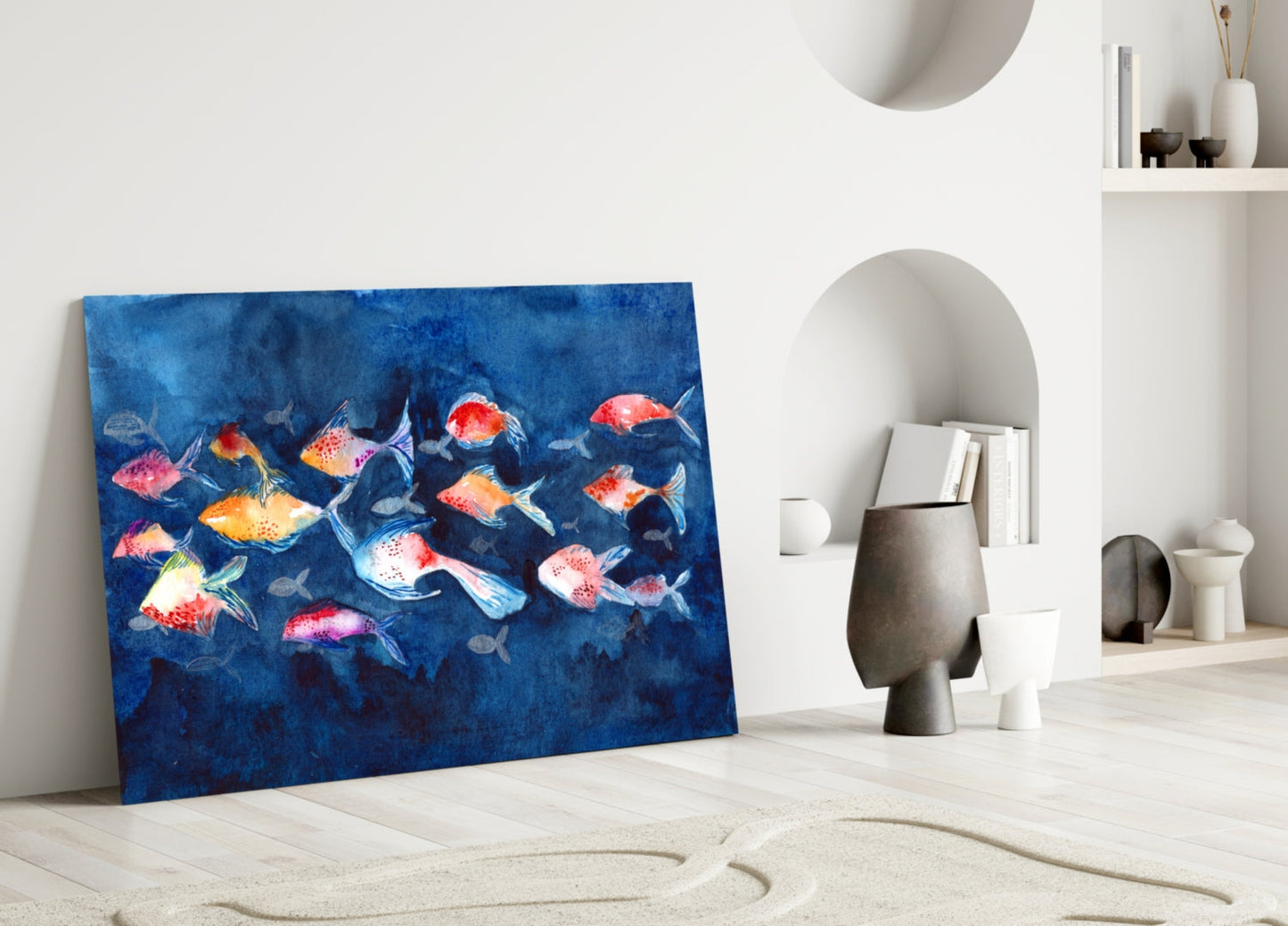 Colorful glass wall art featuring vibrant red, orange, and yellow fish on deep blue background, leaning against white interior wall with shelving.