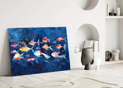 Colorful glass wall art featuring vibrant red, orange, and yellow fish on deep blue background, leaning against white interior wall with shelving.