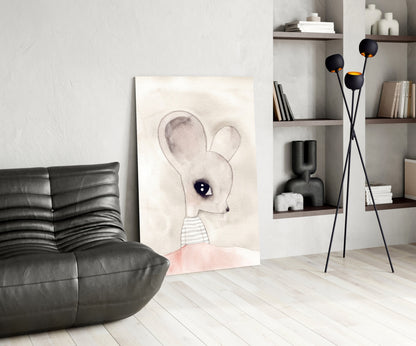 Cute mouse glass wall art displayed on floor against white wall in modern living room with black leather chair and shelving unit.
