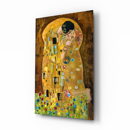 Angled three-quarter view of Klimt's "The Kiss" glass wall art showing the embracing couple in gold tones with ornate patterns and colorful flowers at the base.