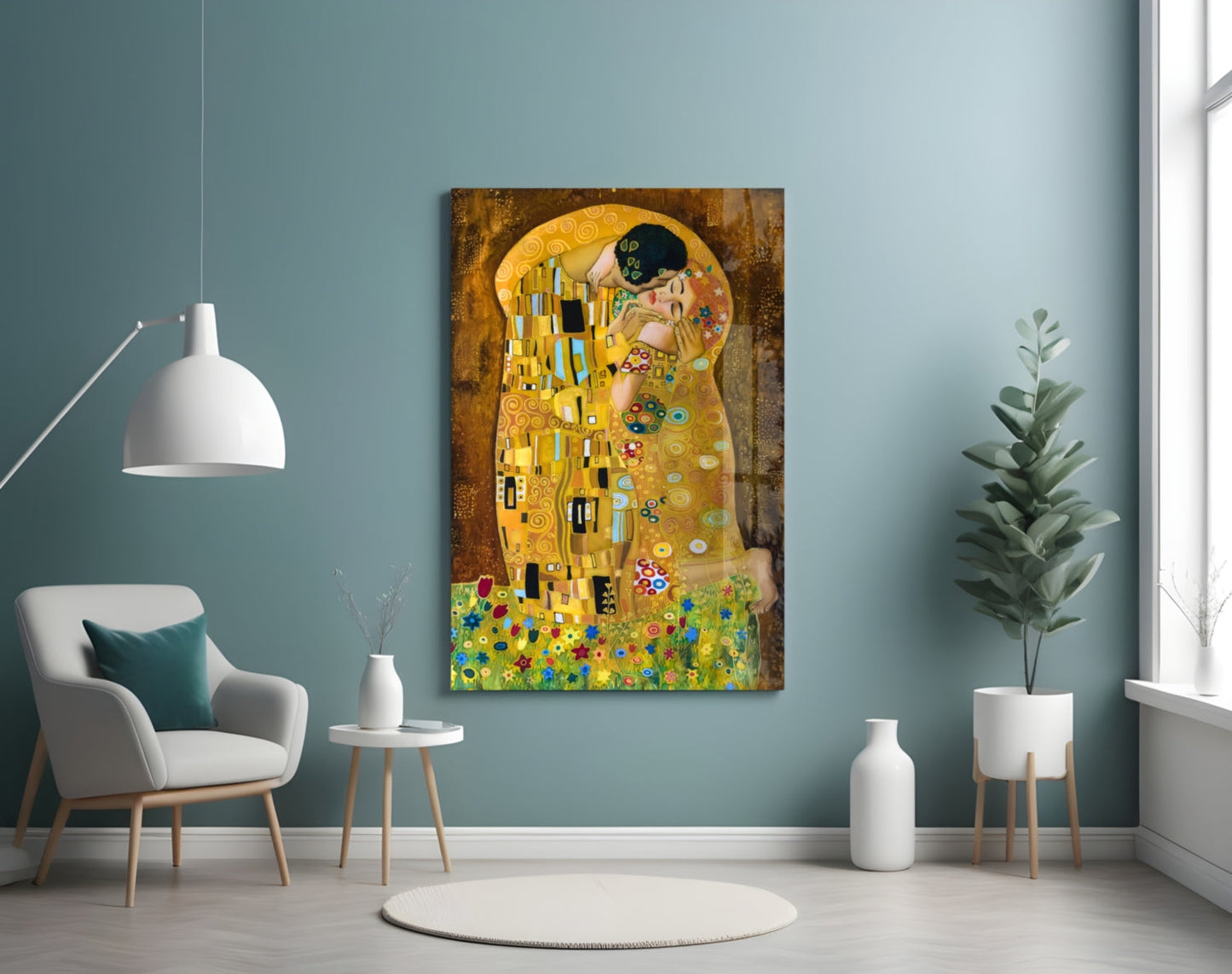 Klimt's "The Kiss" glass art displayed on a muted teal wall above a modern chair and potted plant in a minimalist interior setting.