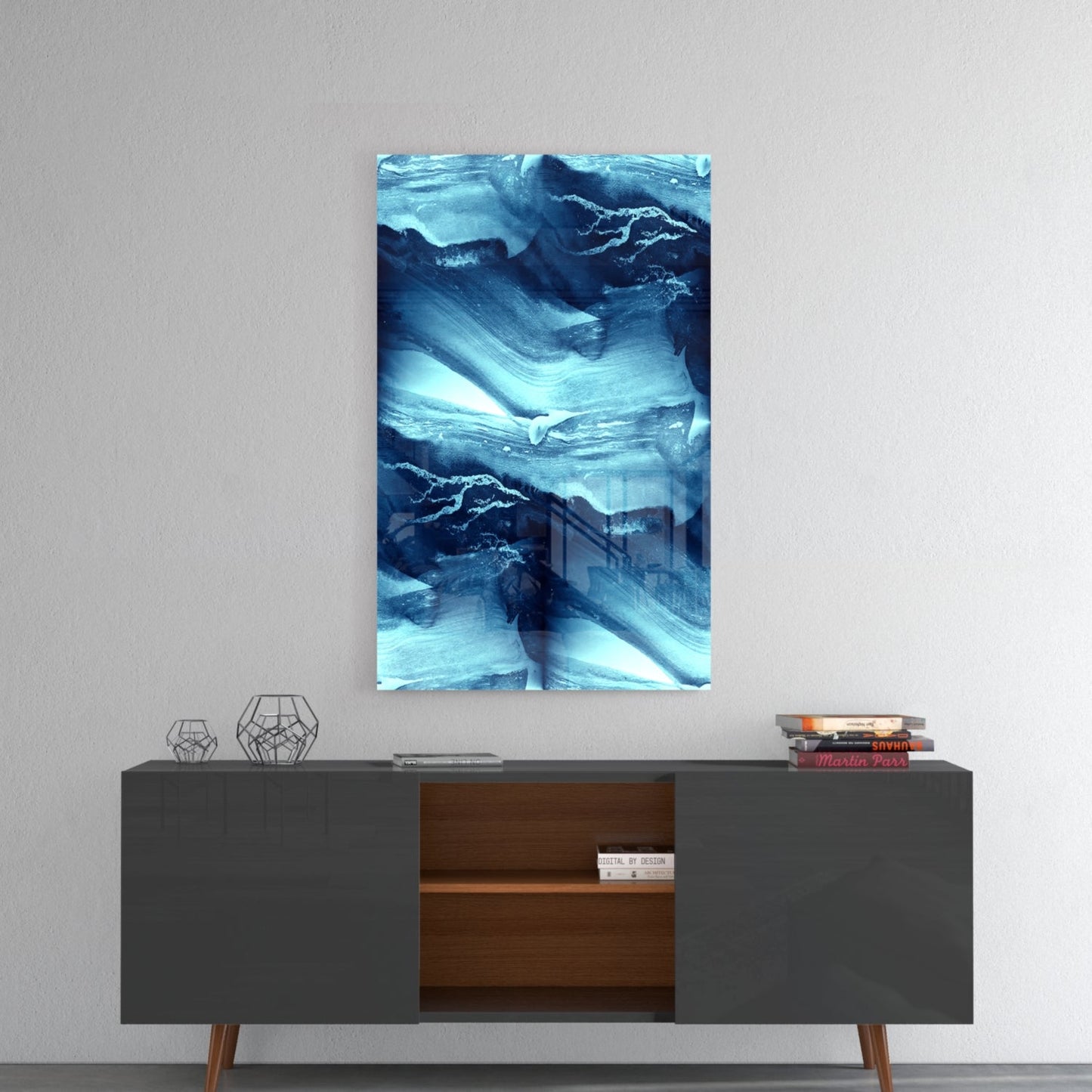 Blue Serenity Glass Wall Art hung above mid-century modern console table with geometric decor and stacked books.