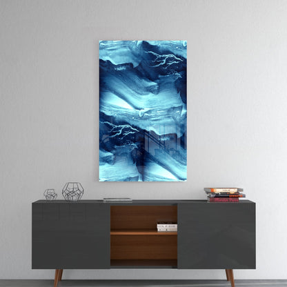 Blue Serenity Glass Wall Art hung above mid-century modern console table with geometric decor and stacked books.