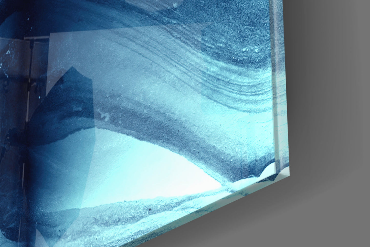 Close-up of textured blue and white glass panel showing layered abstract design with frosted surface detail.
